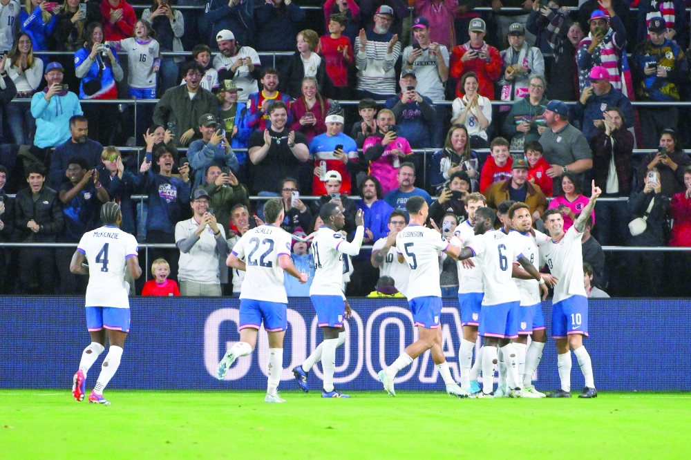 Christian Pulisic (10) is congratulated by teammates after scoring against Jamaica during the first half at Citypark.
