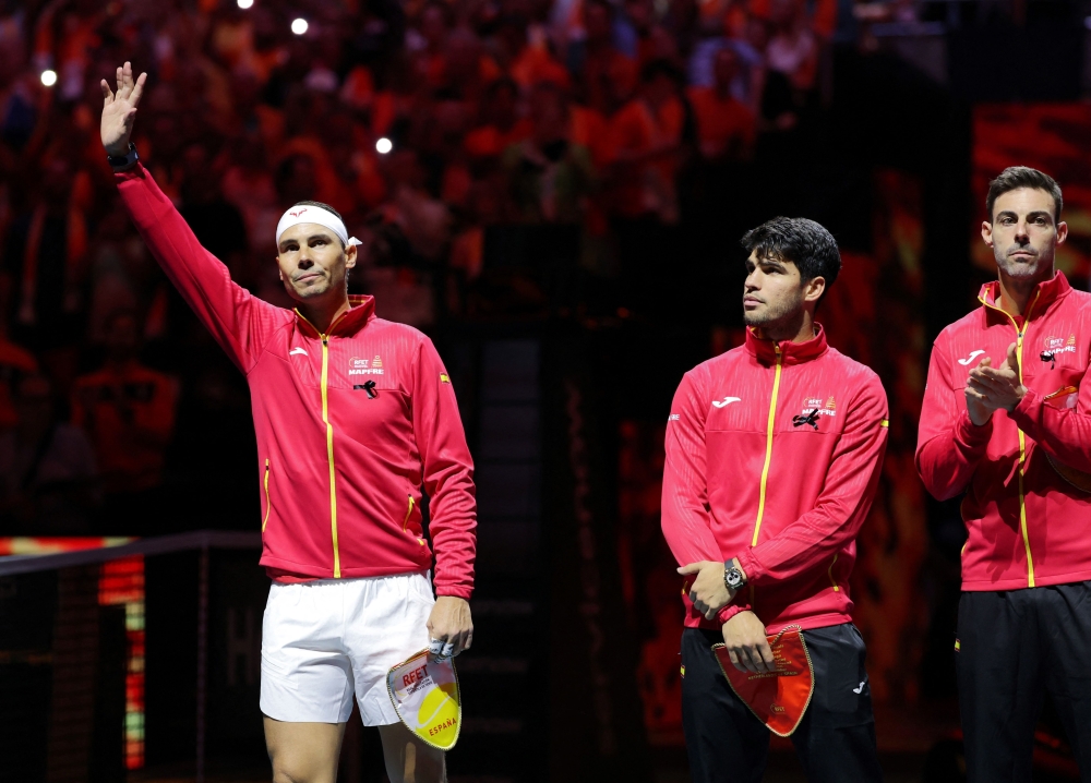 TOPSHOT - Spain's Rafael Nadal (L) waves prior the quarter-final singles match between Netherlands and Spain during the Davis Cup Finals at the Palacio de Deportes Jose Maria Martin Carpena arena in Malaga, southern Spain, on November 19, 2024. The Davis Cup will be the final professional tournament of Nadal's glittering career of almost 23 years. (Photo by Thomas COEX / AFP)

