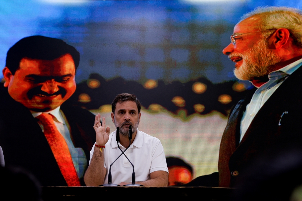 Rahul Gandhi, a senior leader of India's main opposition Congress party, gestures on Indian billionaire Gautam Adani