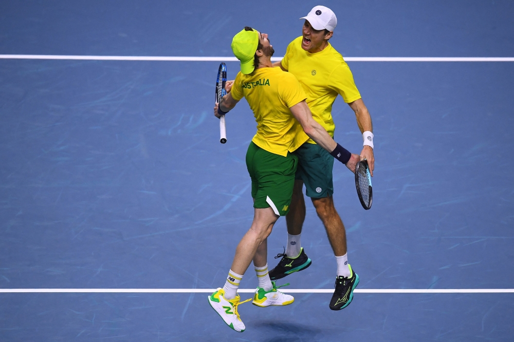Matthew Ebden (R) and Jordan Thompson of Team Australia celebrate beating Tommy Paul and Ben Shelton of Team USA during their quarterfinal 