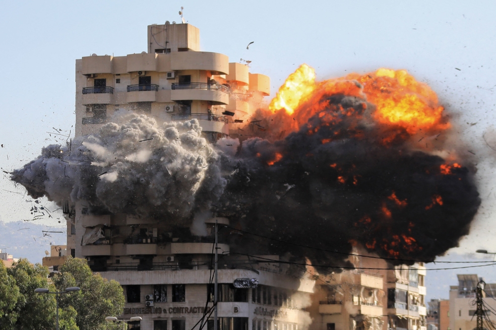  Fire and smoke erupt from a building just after an Israeli airstrike in Beirut's southern Shayah neighbourhood 