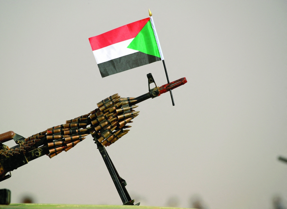A Sudanese national flag is attached to a machine gun 