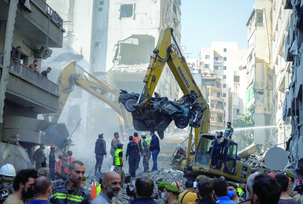 Civil defence members work at the site of an Israeli strike in Beirut's Basta neighbourhood, Lebanon. — Reuters