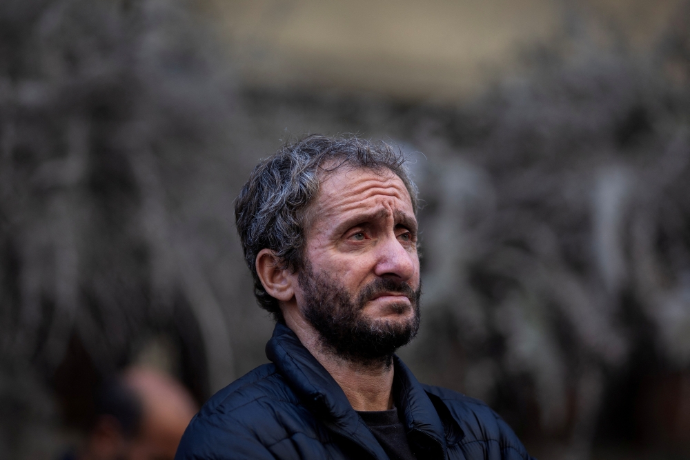 A man reacts as he stands in front of his house at the site of an Israeli strike in Beirut's Basta neighbourhood. REUTERS