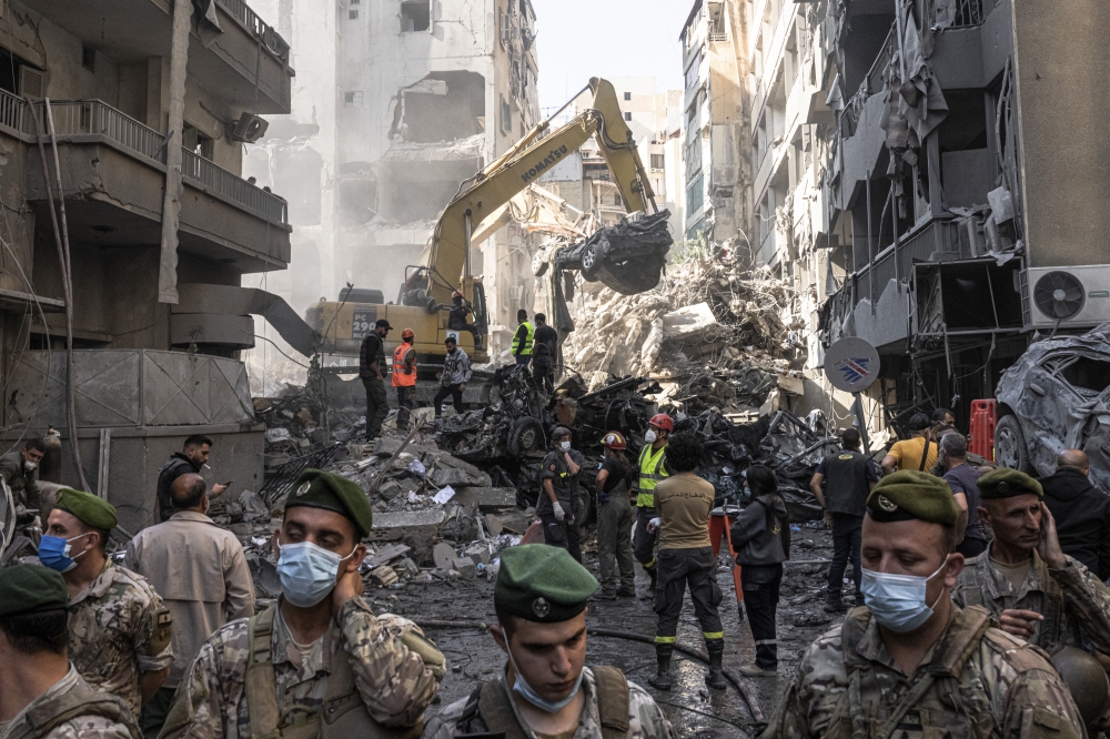 Civil defence members work to retrieve bodies trapped under the rubble after an Israeli airstrike in Beirut. - The New York Times
