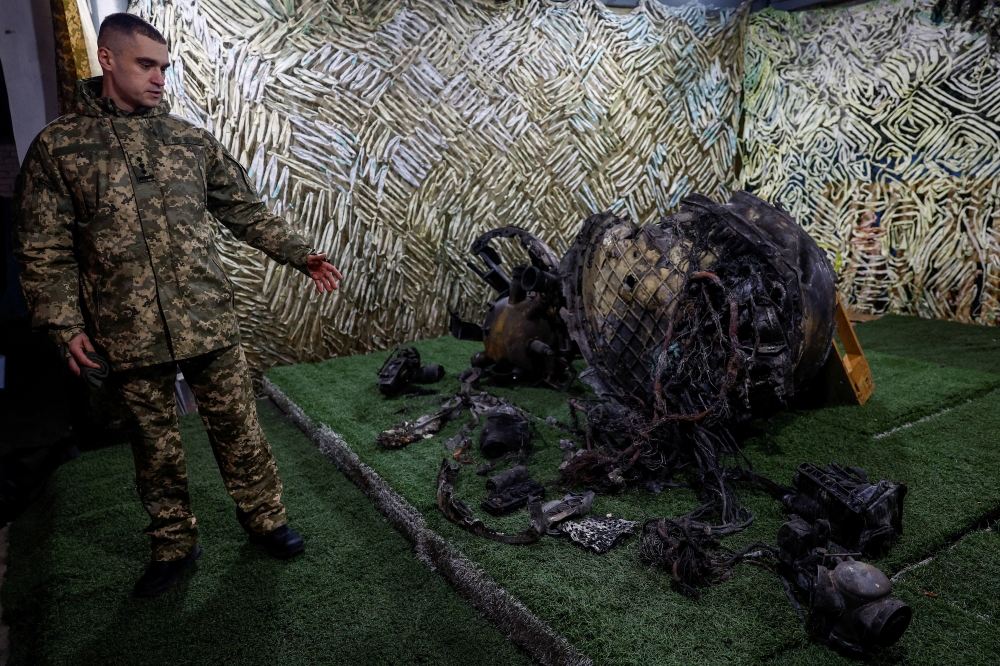 An investigator of the State Security Service of Ukraine (SBU) shows parts of a ballistic missile, which Russia used in a strike towards Dnipro city, in Ukraine. — Reuters
