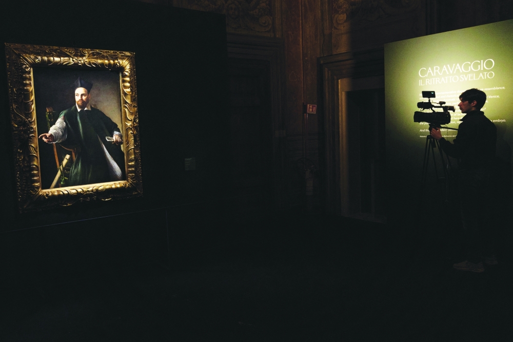 A camera person stands near Caravaggio's Portrait of Monsignor Maffeo Barberini which was unveiled at the National Gallery of Ancient Art, before going on public display for the first time in Rome, Italy, November 22, 2024. REUTERS/Remo Casilli