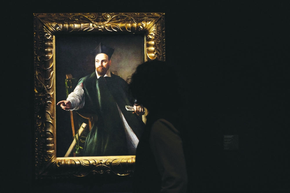 A person walks next to Caravaggio's portrait of Monsignor Maffeo Barberini which was unveiled at the National Gallery of Ancient Art, before going on public display for the first time in Rome, Italy, November 22, 2024. REUTERS/Remo Casilli