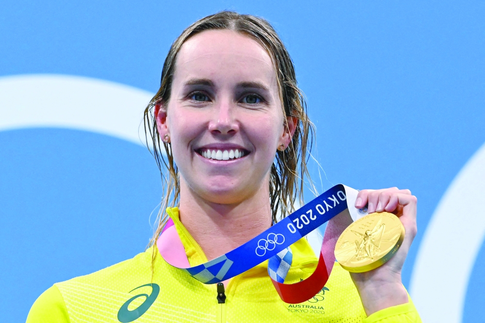 Australian gold medallist Emma McKeon with her medal on the podium — AFP