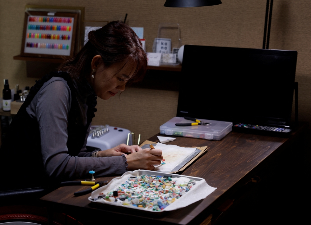 Japanese manicurist Naomi Arimoto makes a decorative nail tip using plastic waste which she collected from the beach, at her nail salon in Chigasaki, Kanagawa Prefecture, Japan October 21, 2024. REUTERS/Manami Yamada

