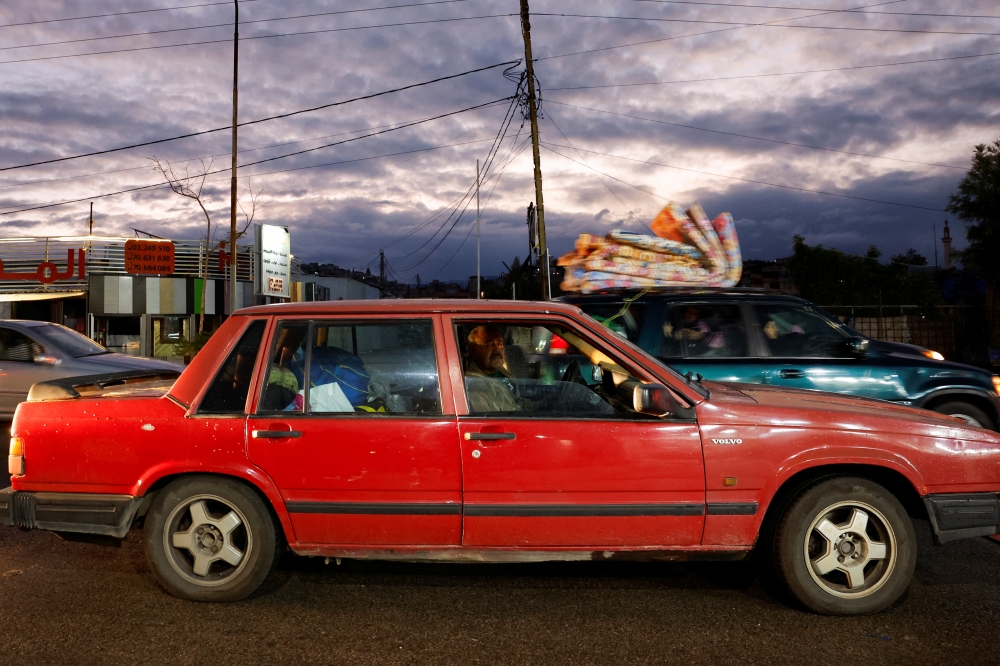 A man looks on from his car window as he drives to southern Lebanon after a ceasefire between Israel and Hezbollah took effect 