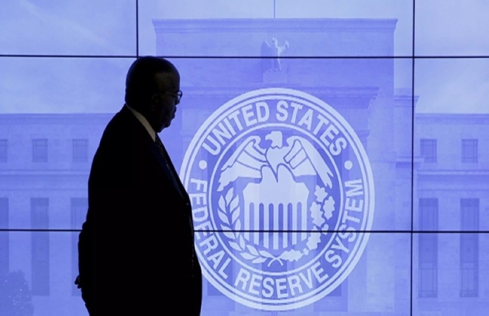 A man walks past the logo of US Federal Reserve in Washington. — AFP