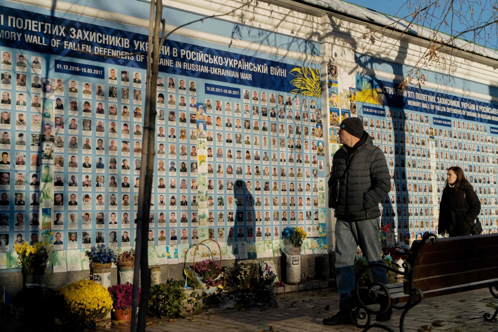 People walk past the "Wall of Remembrance of the Fallen for Ukraine" in Kyiv. — AFP