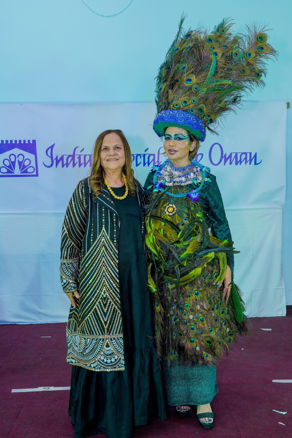 Devyani Sampat, a renowned floral artist, with a model at a fashion show for the Indian Social Club