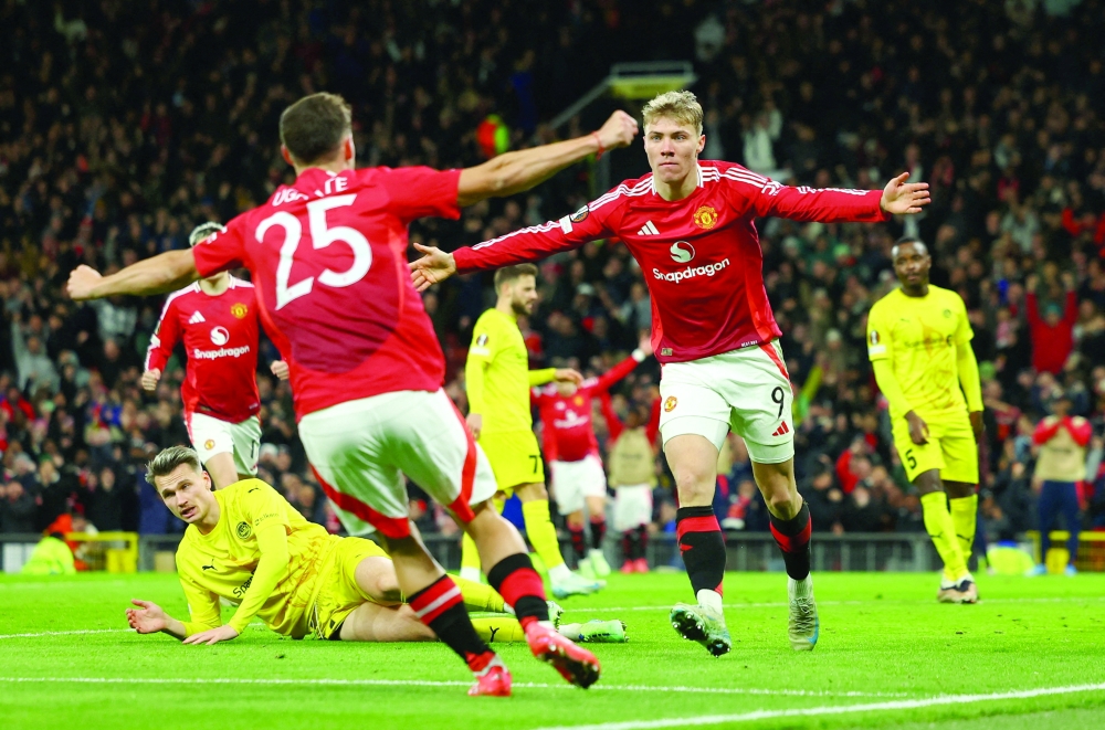 Manchester United's Rasmus Hojlund celebrates scoring their third goal with Manuel Ugarte. REUTERS