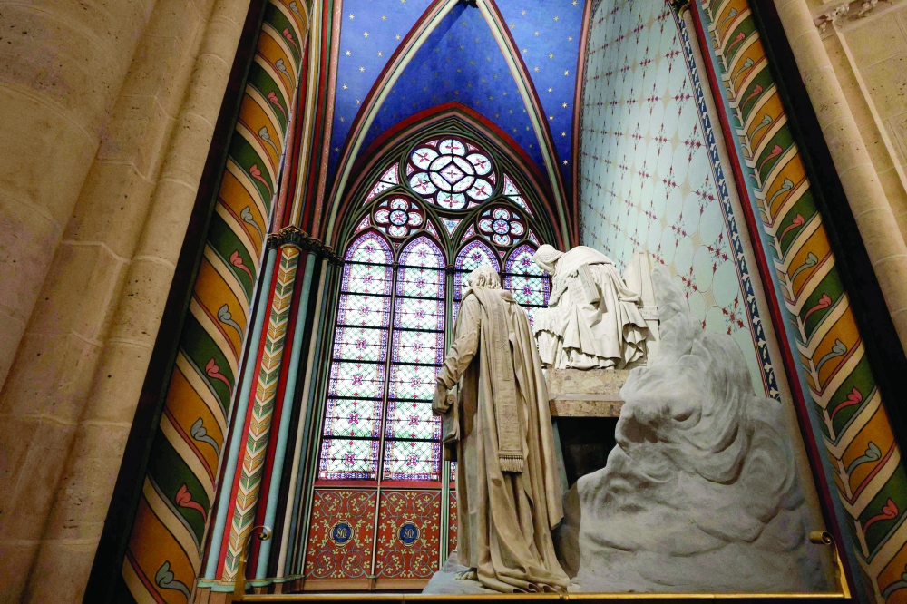 A statue and windows inside Notre-Dame de Paris cathedral in Paris. — AFP