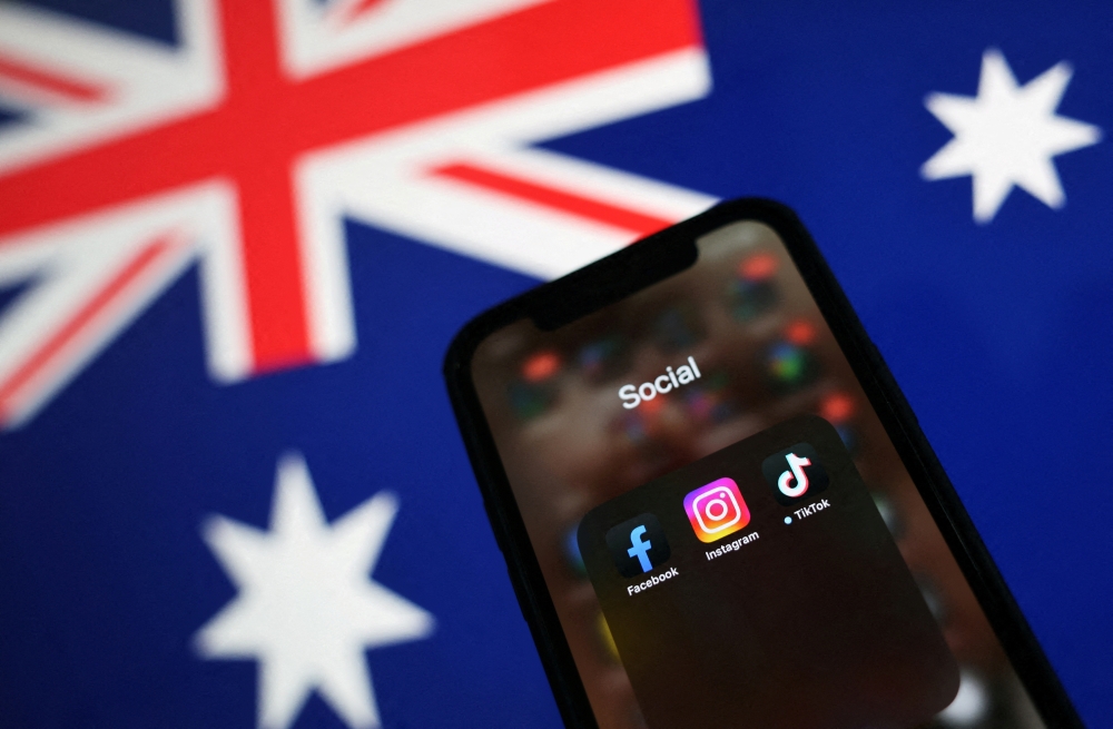 Facebook, Instagram, and TikTok apps are seen on a smartphone in front of an Australian flag, in this illustration taken November 29, 2024. 