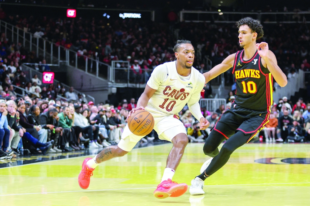 Darius Garland (10) drives the ball against Zaccharie Risacher (10). — Reuters