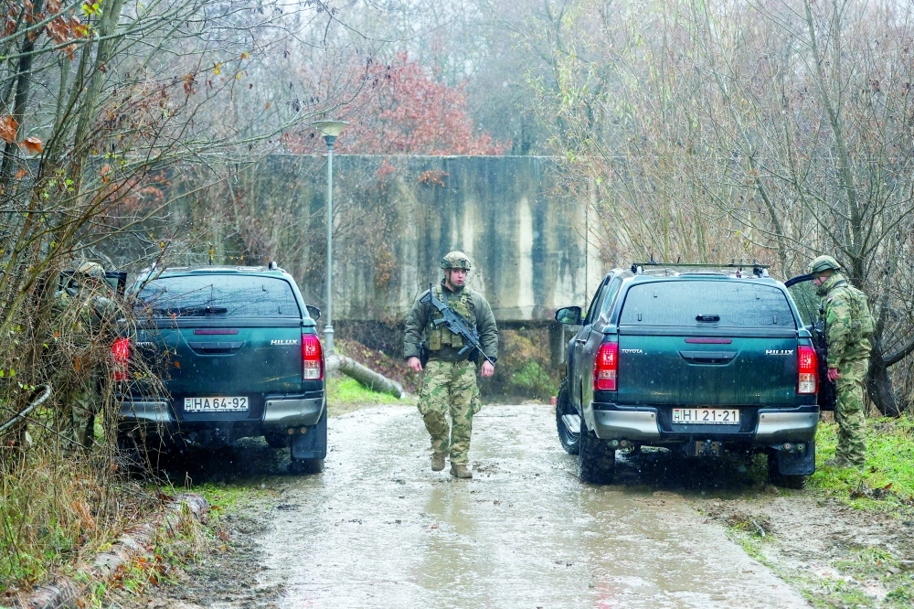 Hungarian soldiers, part of the Nato-led peacekeeping force KFOR, patrol near the damaged canal in northern Kosovo. — Reuters 