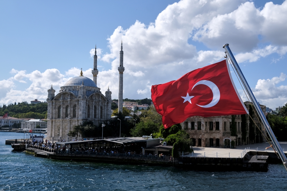 A Turkish flag is pictured on a boat with the Ortakoy Mosque in the background in Istanbul. — Reuters