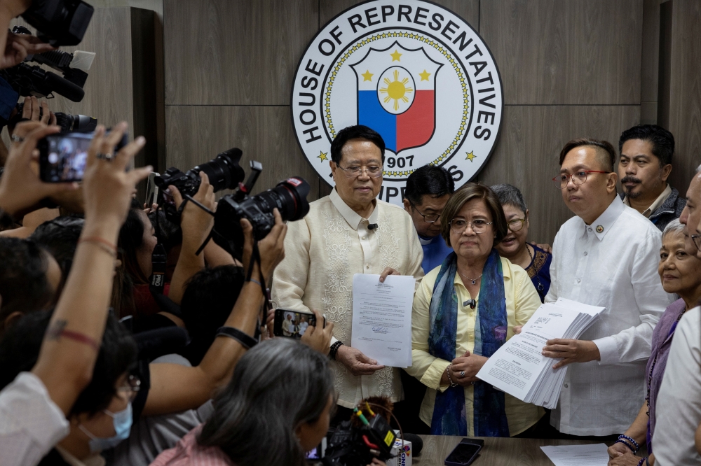 Philippine House of Representatives Secretary General Reginald Sagun Velasco holds the impeachment complaint against Vice President Sara Duterte, at the House of Representatives in Quezon City. — Reuters 