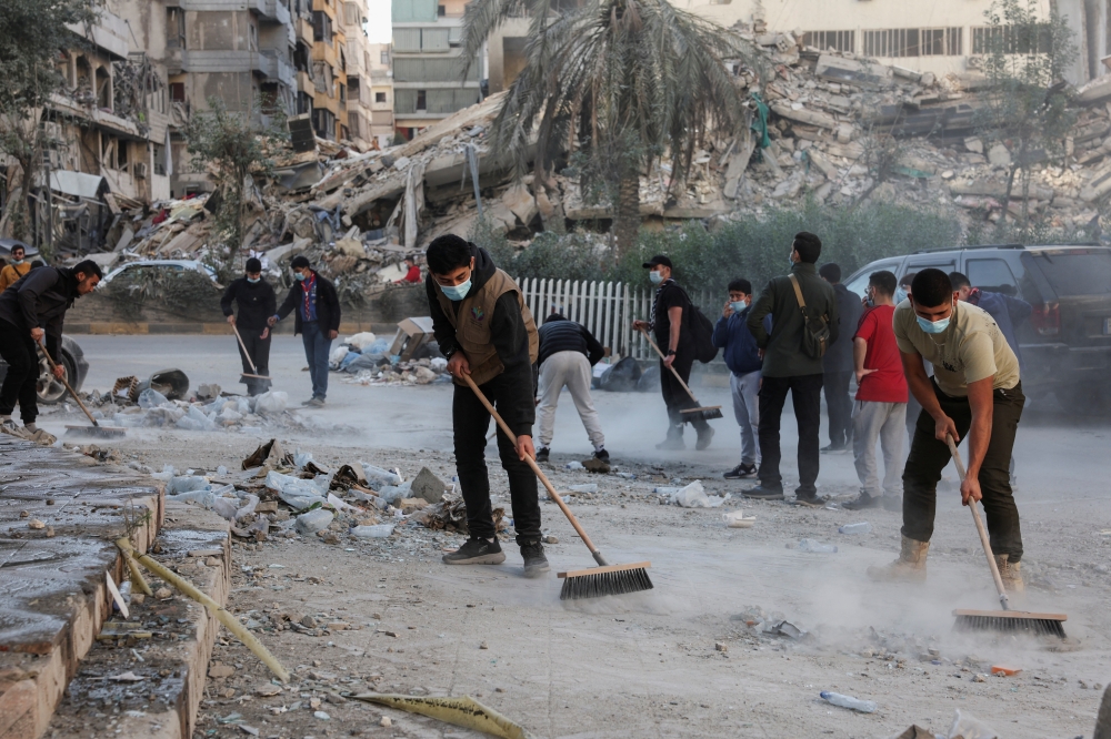 Members scouts clean rubble and debris from damaged buildings in Beirut's southern suburbs. — Reuters 