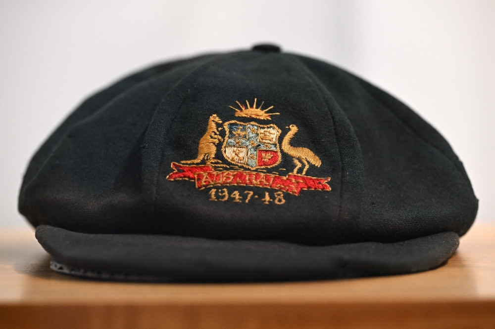 A cap worn by Australia's greatest cricket legend Don Bradman is on display at an auction house Bonhams in Sydney on December 2, 2024.  The cap will be auctioned in Sydney on December 3, 2024, with the tattered "baggy green" expected to fetch as much as 260,000 USD. (Photo by Saeed KHAN / AFP)

