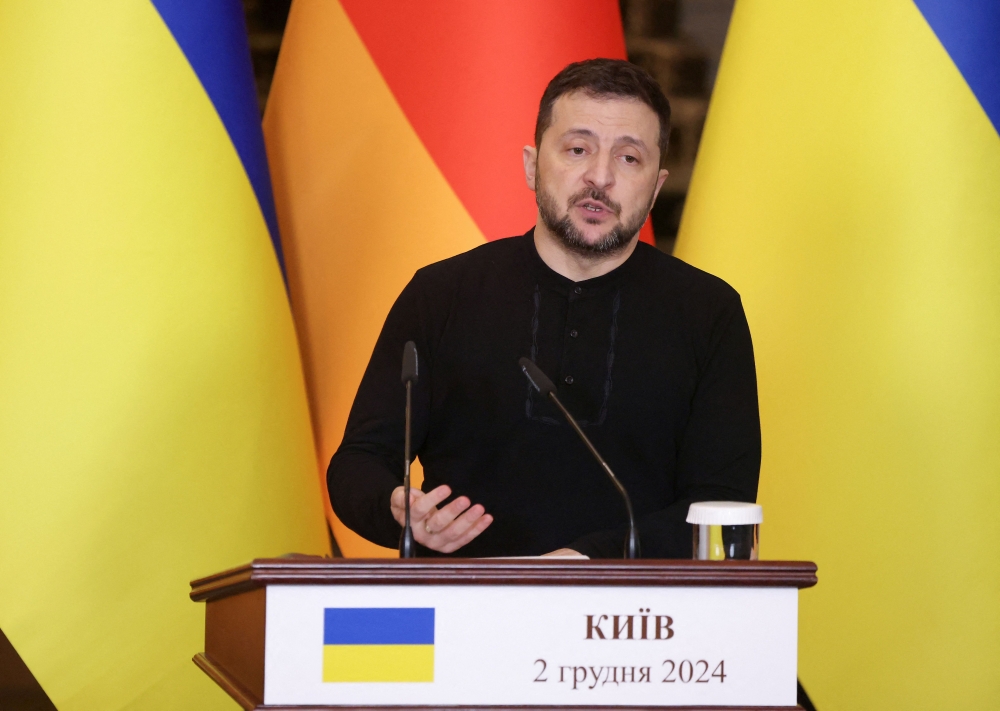Ukrainian President Volodymyr Zelensky addresses the audience during a joint press conference with German Chancellor at Saint Sophia Cathedral in Kyiv, on December 2, 2024, amid the Russian invasion in Ukraine. (Photo by Anatolii STEPANOV / AFP)