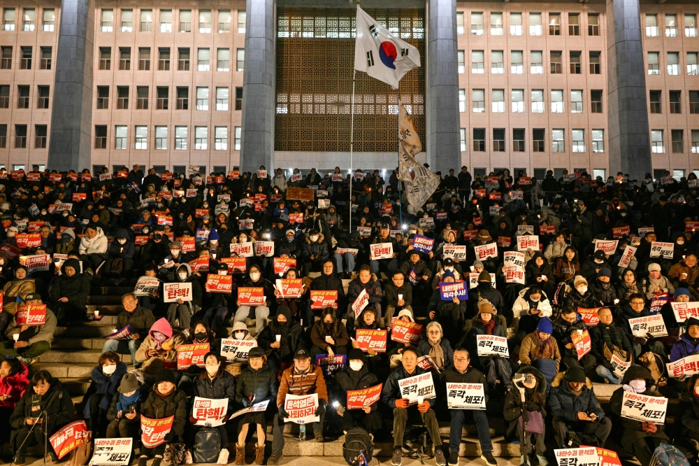 People call for the resignation of South Korea President as they take part in a protest, the National Assembly in Seoul. — AFP 