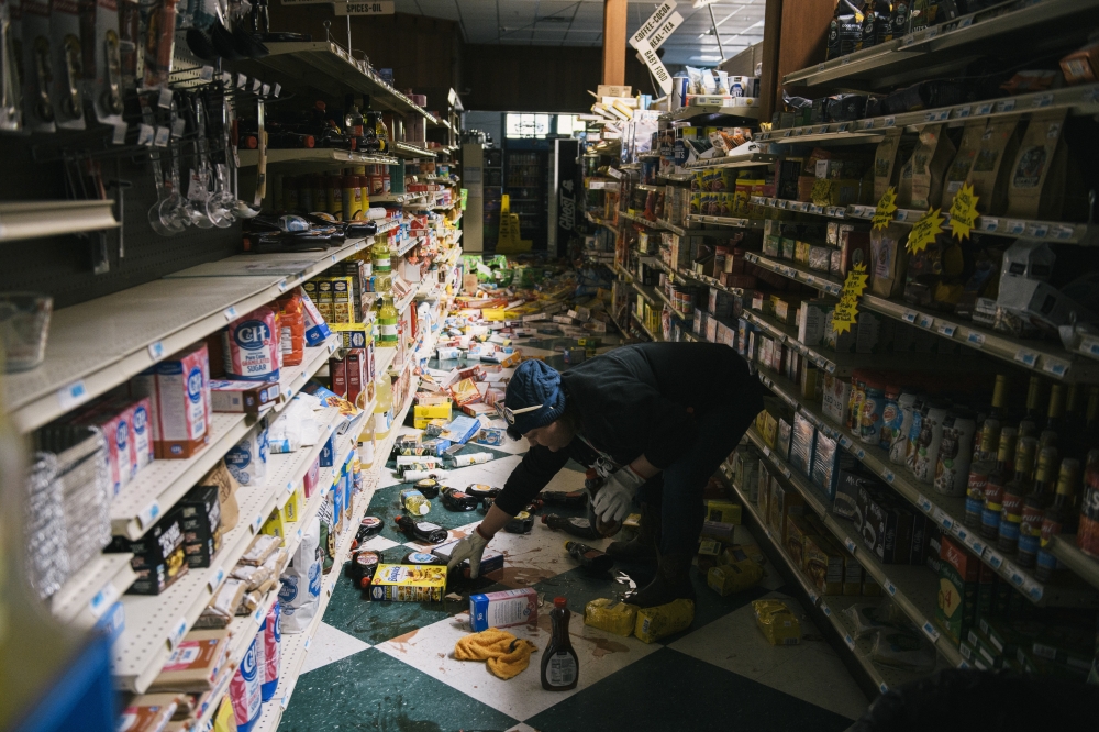 Cleaning up fallen items at a Market after an earthquake struck off the coast on Thursday, Dec. 5, 2024. 