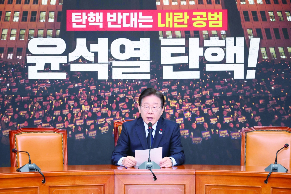 South Korea's main opposition Democratic Party leader Lee Jae-myung (C) speaks during a press conference at the National Assembly in Seoul. — AFP