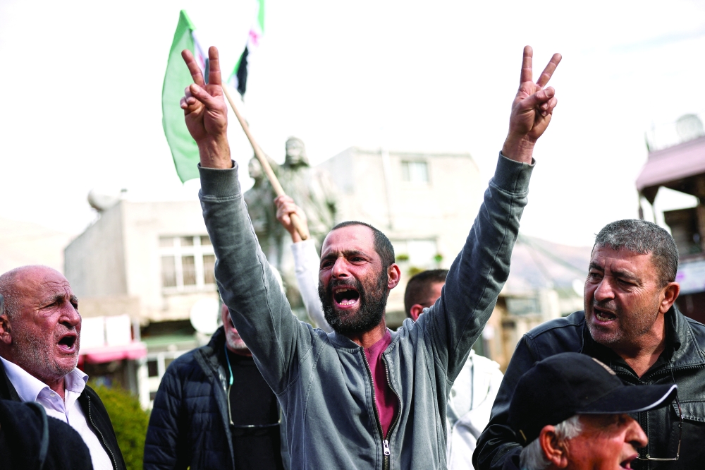 A Syrian man gestures, as people celebrate in Majdal Shams, a Druze village in Golan Heights. — Reuters 