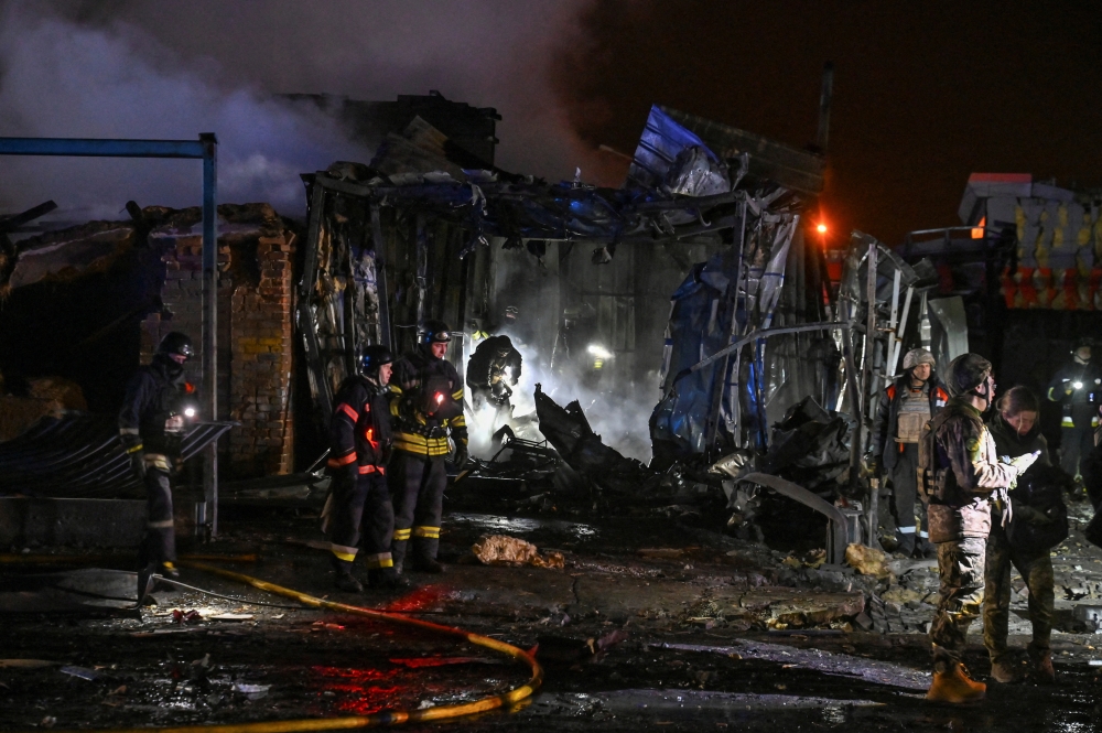 Firefighters work at the site of a car maintenance workshop heavily damaged by a Russian air strike, in Zaporizhzhia. — Reuters 
