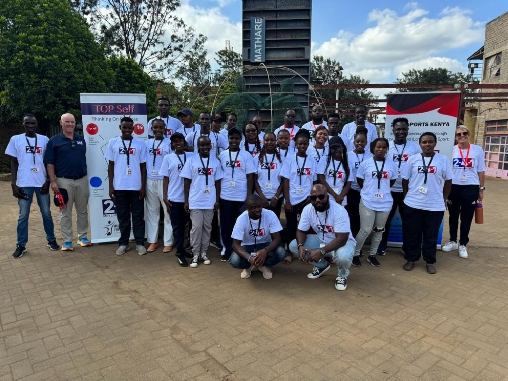 Members of Wellness for Greatness Kenya engage with young participants during a sports activation event