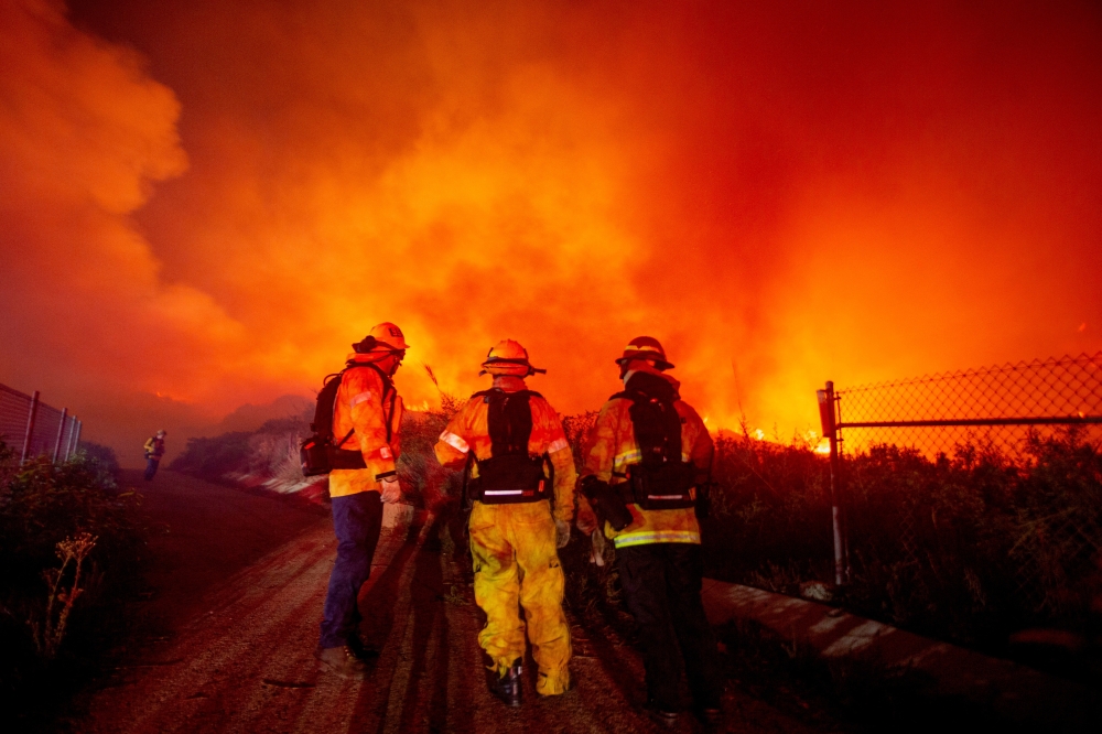 Firefighters watch as the Franklin fire burns in Malibu, California. — Reuters 