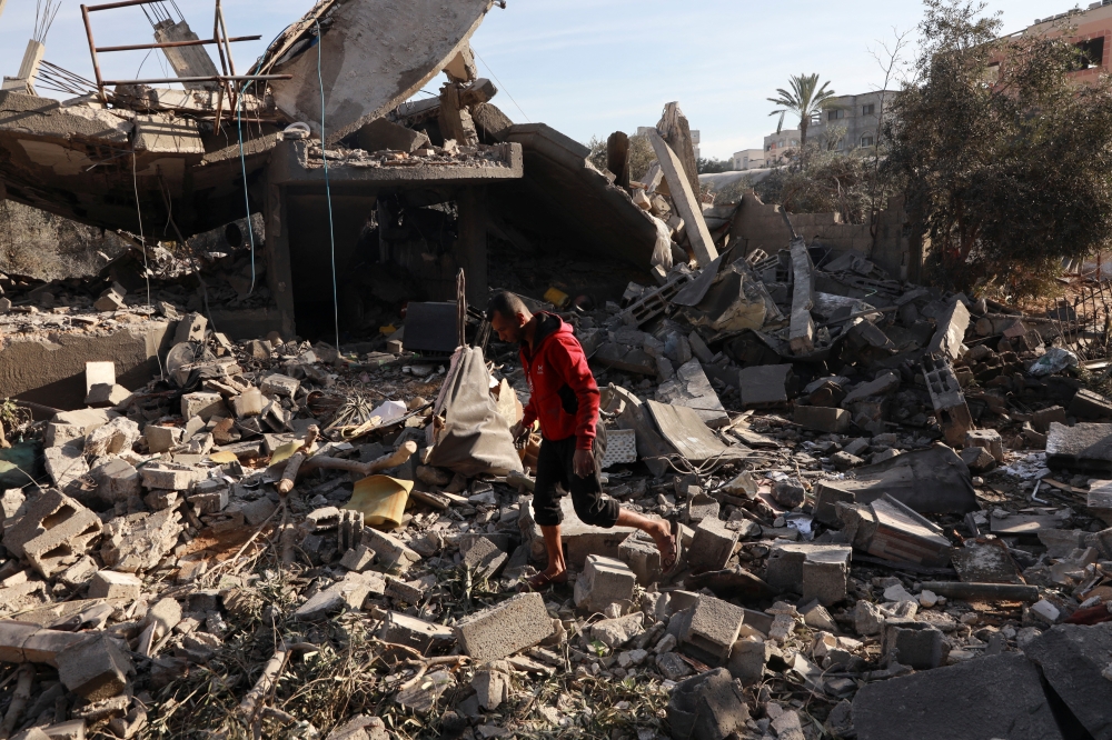 A Palestinian man inspects the site of an Israeli strike on a house in Nuseirat, central Gaza Strip. — Reuters 