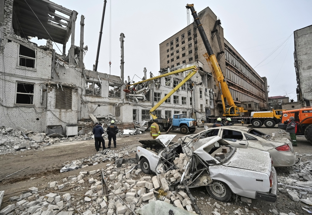 Rescuers work at the site where a building was heavily damaged by yesterday's Russian missile strike, in Zaporizhzhia, Ukraine. — Reuters 