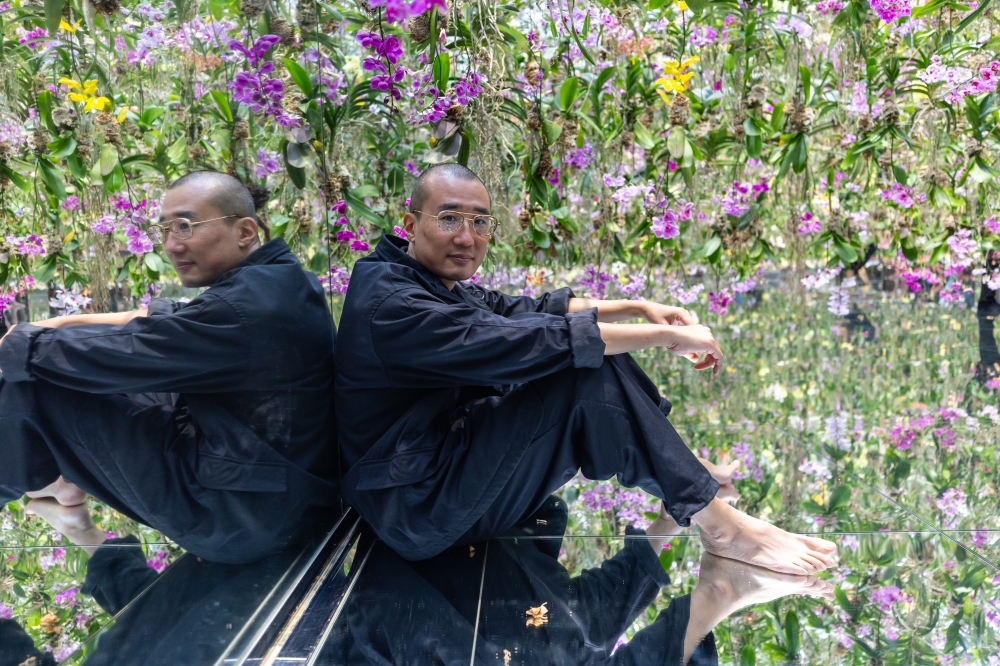 Takashi Kudo, a core member of teamLab, in the orchid room at teamLab Planets in Tokyo, Oct. 4, 2024. (Shiho Fukada/The New York Times)