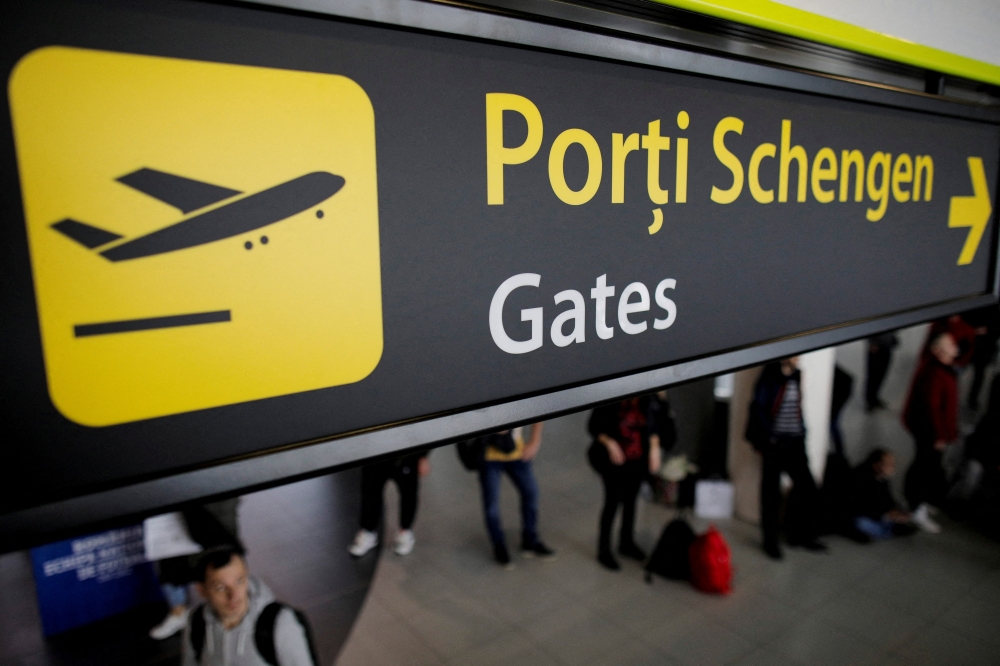 Airport signage showing passengers the route to the Schengen gates can be seen installed in Henri Coanda International Airport near Bucharest. - Reuters File