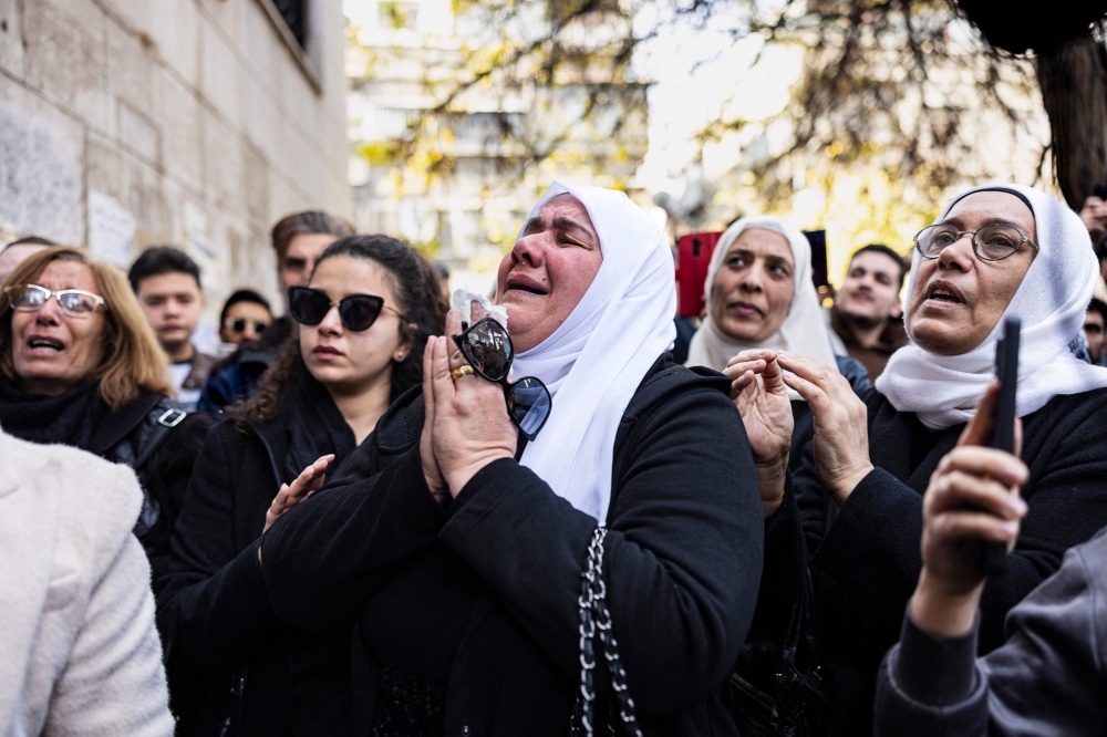 Mourners attend the funeral of Syrian activist Mazen al-Hamada, whose body was found recently in the capital Damascus. - AFP