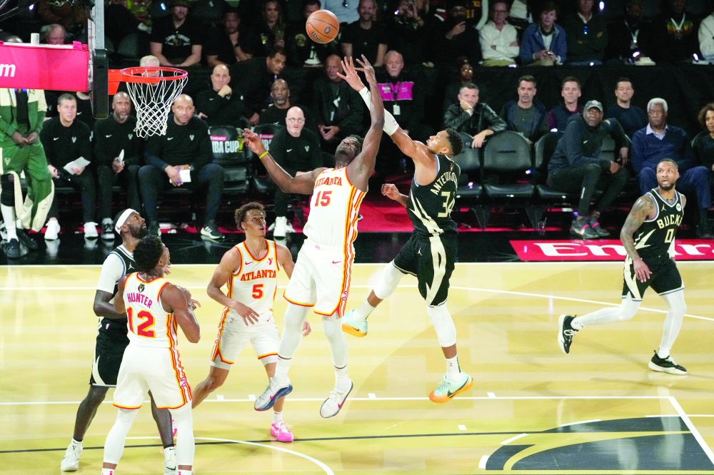 Giannis Antetokounmpo (34) shoots against Clint Capela (15). — Reuters