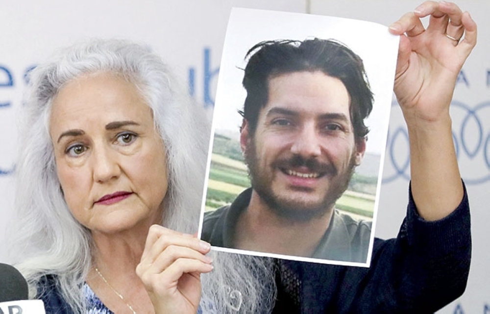 Debra Tice, mother of US journalist Austin Tice who was kidnapped in Syria holds a dated portrait of him during a press conference in the Lebanese capital Beirut. - AFP 