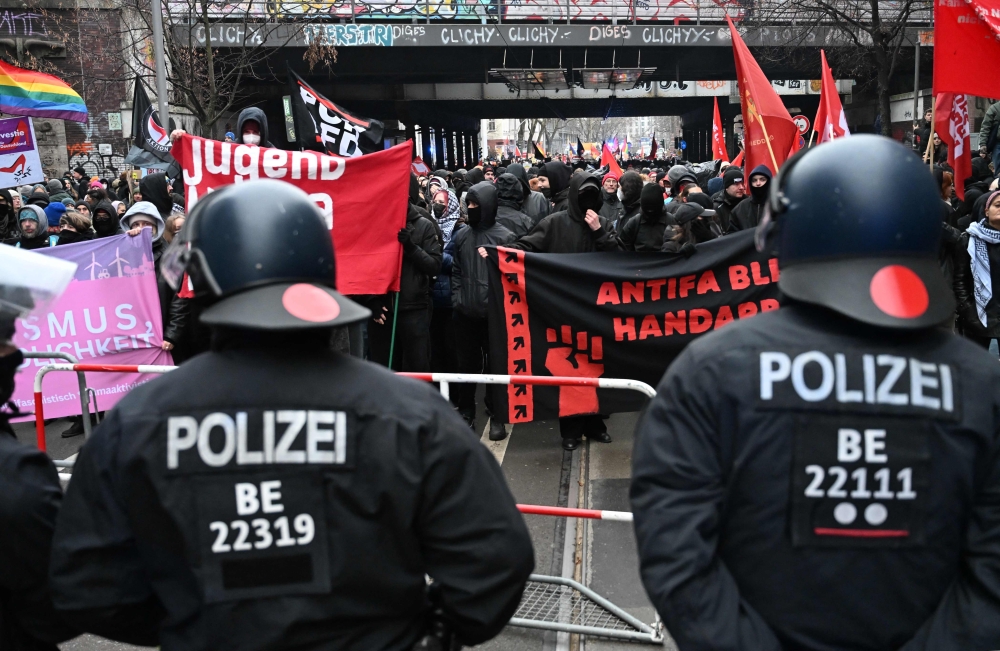 Police face left-wing demonstrators rallying at Ostkreuz station, Berlin. — AFP 