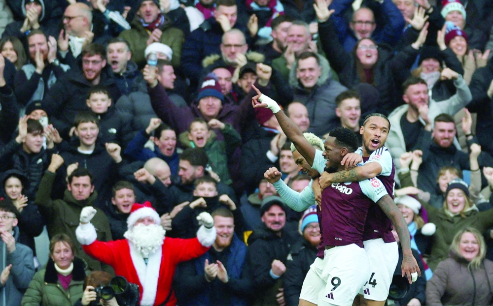  Villa's Jhon Duran celebrates scoring their first goal with Boubacar Kamara as a fan dressed as Father Christmas is seen celebrating Action Images via Reuters