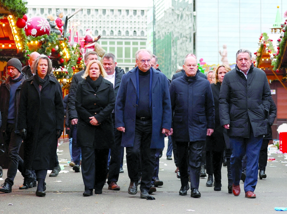 German Chancellor Olaf Scholz, Prime Minister of Saxony-Anhalt Reiner Haseloff, and German Interior Minister Nancy Faeser visit the site where a car drove into a crowd at a Christmas market in Magdeburg, Germany. — Reuters