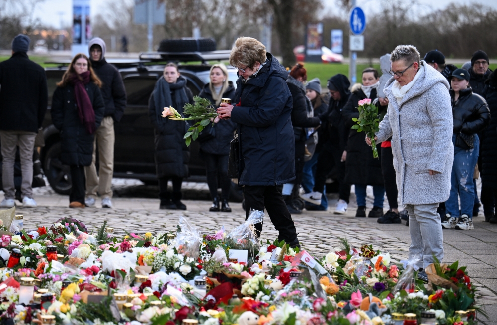 People leave candles and floral tributes near the 'Alter Markt' Christmas market, in Magdeburg, Germany. — Reuters 
