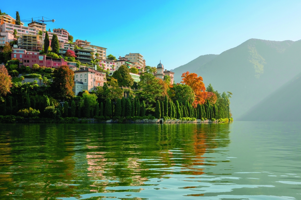 The gardens of the Villa Favorita in Lugano, Switzerland stretch down to the waters of Lake Lugano, and the upper reaches of the mansion peek out above the treetops, on Nov. 1, 2024. (Maurizio Fiorino/The New York Times)