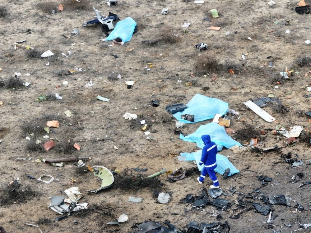 A drone view shows an emergency specialist approaching the bodies of the victims 