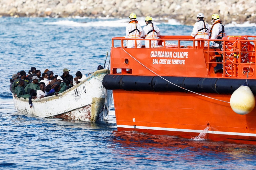 A Spanish Coast Guard vessel tows a fibreglass boat with migrants onboard to the port of Arguineguin, on the island of Gran Canaria, Spain. — Reuters