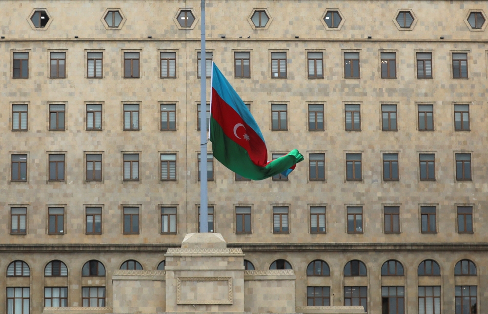 An Azeri state flag flies at half-mast as the country observes the day of national mourning, outside the Government House in Baku. — Reuters 